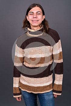 Young androgynous man with long hair ready for winter