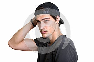 Studio shot of young handsome man wearing snapback while posing