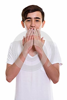 Studio shot of young handsome Persian teenage boy looking shocke