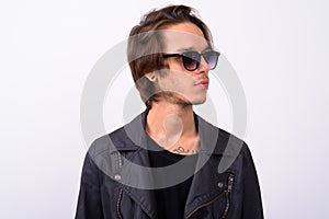 Young handsome rebellious man against white background