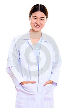 Studio shot of young happy Asian woman doctor smiling with hands