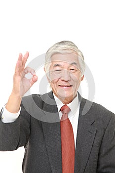 Senior Japanese businessman showing perfect sign
