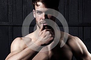 Studio shot of young man looking at the camera. Handsome guy with confident face. Mens sexuality or attraction and
