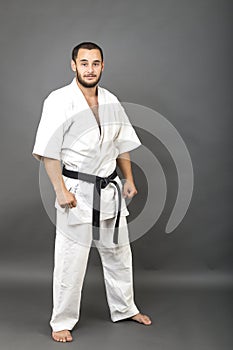 Studio shot of young man in white kimono and black belt