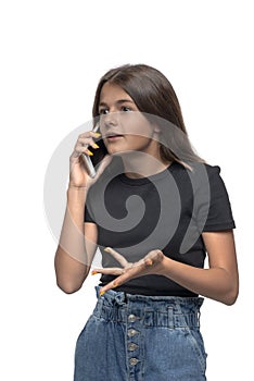 Studio shot of young serious teenager girl, isolated