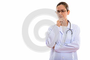 Studio shot of young stressed woman doctor thinking while lookin