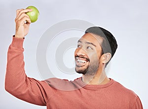 Studio smile, happy and man with apple product for weight loss diet, healthy lifestyle change or body nutrition goals