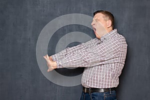 Portrait of man with arms stretched while yawning