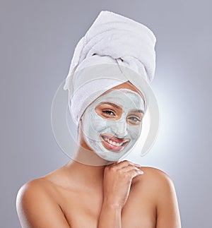 Studio, woman and face mask for skincare, cosmetic and facial treatment on white background. Beauty, towel or portrait