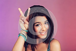 Studio, woman and portrait with closeup, peace sign and beauty with smile, confidence and face. Latino teen, happy and