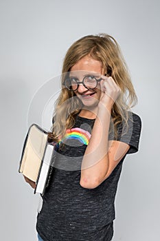 Studious Girl Holding Books and Smiling at the Camera