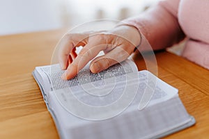 Studious Senior Close-Up of Cropped Hands Holding Textbook