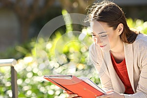 Studious student reading notes in a park or campus photo
