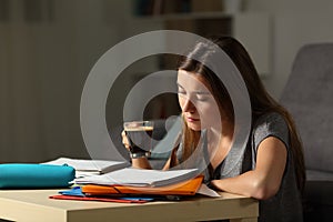 Studious student studying holding a coffee cup