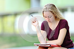 Studious student studying memorizing notes photo