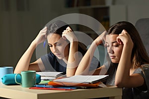 Studious students memorizing late hours in the night at home photo