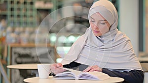 Studious Young Arab Woman Reading Book