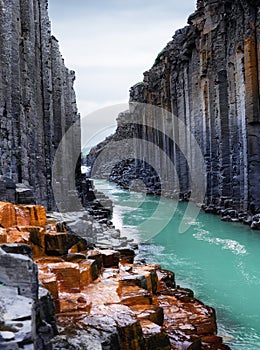 Studlagil basalt canyon in Iceland. Most famous and popular place in Iceland. River in canyon.