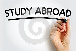 STUDY ABROAD underlined text with marker, concept background