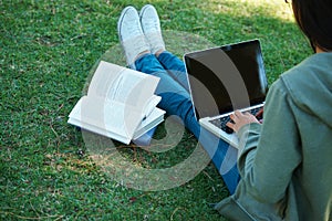 Study, book and person with laptop in park on campus for research, report and education at college. University, student