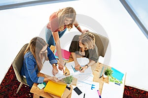 Study group in progress. High angle shot of two female university students working on a project together at a table on