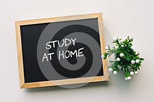 STUDY AT HOME text in white chalk handwriting on a blackboard