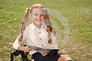 Study language. Cute smiling small child hold book. Adorable little girl school student. School education concept. Cute