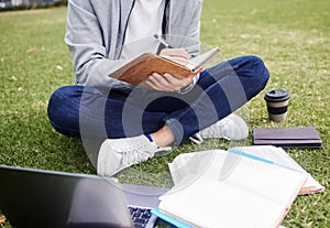 Study, laptop and student in park writing at university, college or campus for education research, planning schedule or