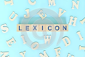 Study lexicon in linguistics concept. Wooden blocks word typography flat lay in blue background.