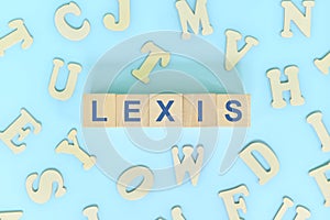 Study lexis in linguistics concept. Wooden blocks word typography flat lay in blue background. photo