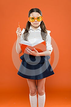 Study literature. Pupil likes study. Small girl enjoying her school time. Happy little schoolgirl ready for lesson. Cute