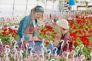 study and next generation, woman and child busines familiar with greenhouse plants