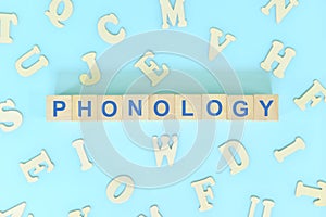 Study phonology in linguistics concept. Wooden blocks word typography flat lay. photo