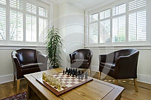 Study room with leather armchairs and chess board