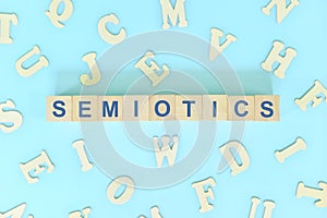 Study semiotics in linguistics concept. Wooden blocks word typography flat lay in blue background.