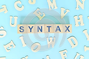 Study syntax in linguistics concept. Wooden blocks word typography flat lay in blue background. photo