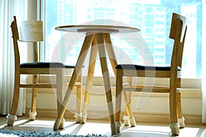 study table and chair in a home near window curtain