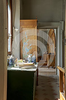 Study view with sideboard with books, magazines and a mug of beer on it