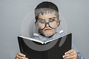 Studying, Boy with giant glasses reading a book with funny and v