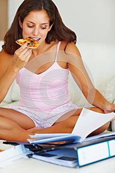 Studying, eating and woman on bed with pizza for dinner, lunch or supper reading documents. Paperwork, textbook and