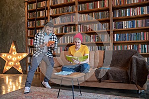 Young man in a yellow tshirt studying before exams with his friend photo