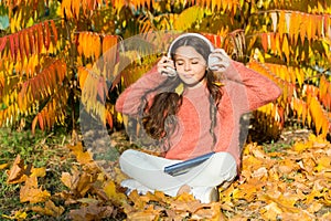 Studying twice faster using visual and audio information. Little child enjoy learning in autumn park. Kid study with