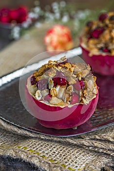 Stuffed baked red apples with granola, cranberries and marzipan
