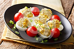 Stuffed deviled eggs with canned tuna and avocado served with to