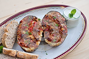 Stuffed Eggplant halves with tomato onion sweet pepper and cheese.