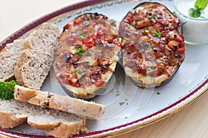 Stuffed Eggplant halves with tomato onion sweet pepper and cheese.