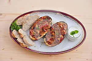 Stuffed Eggplant halves with tomato onion sweet pepper and cheese.