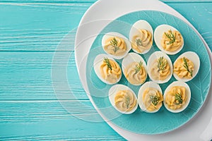 Stuffed eggs on blue plate for easter table