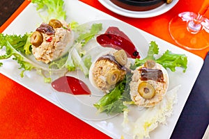 Stuffed eggs with cheese filling and olives, served with lettuce