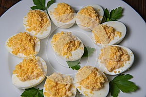 Stuffed eggs with crab crumbs, mayonnaise and parsley macro on a plate